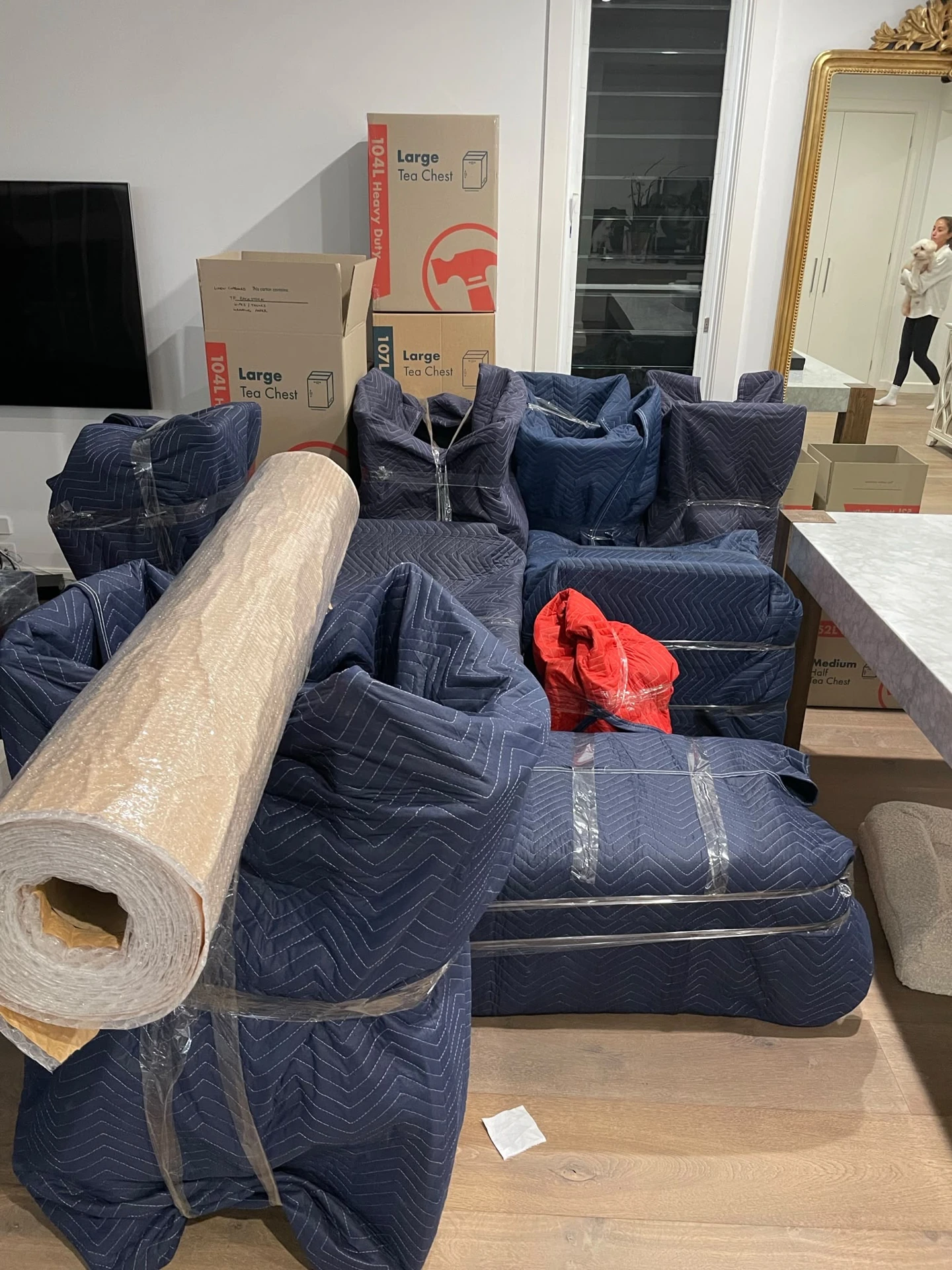 Household furniture individually wrapped in blankets and film before loading