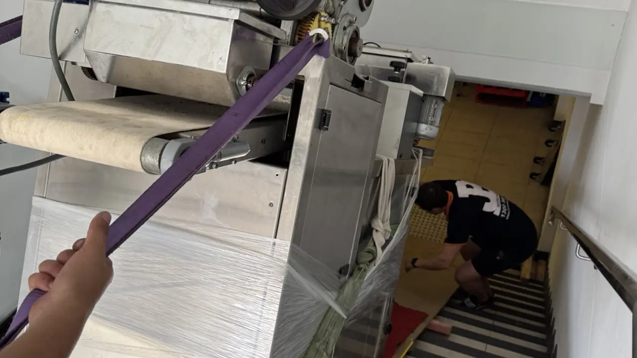 JB specialists controlling a 500 kilogram machine down a prepared stair route