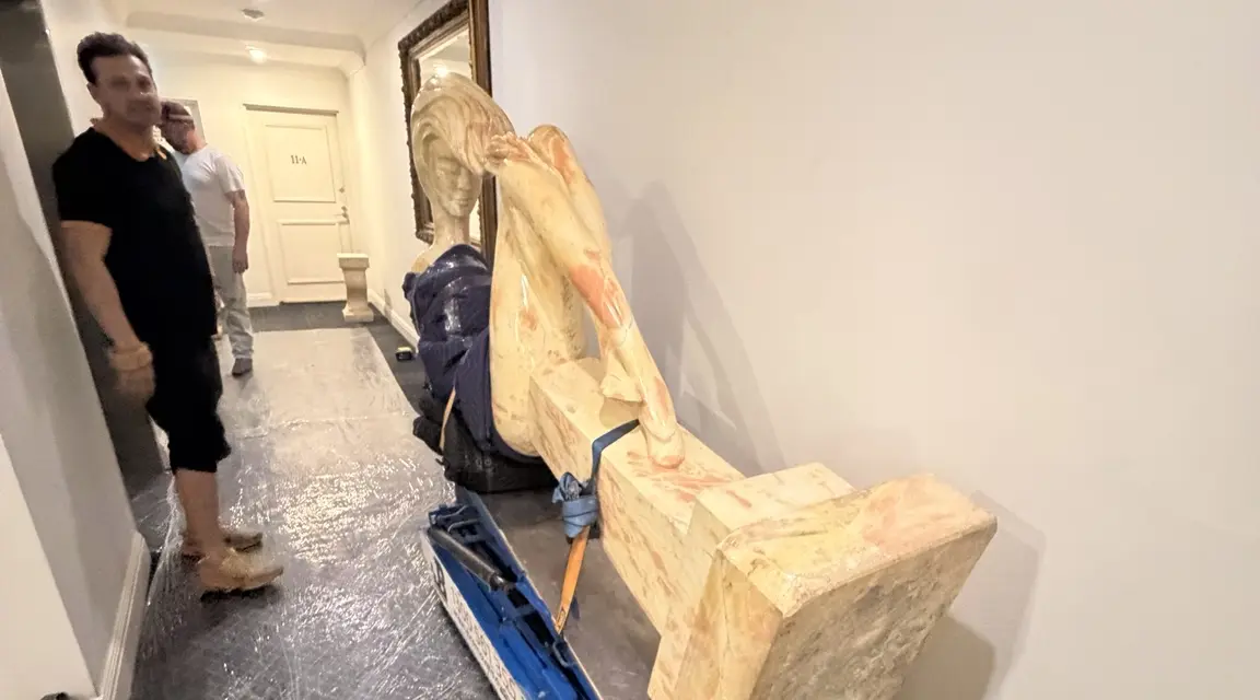 A 700kg marble sculpture mechanically tilted on a JB Removals stair climber inside a protected building corridor