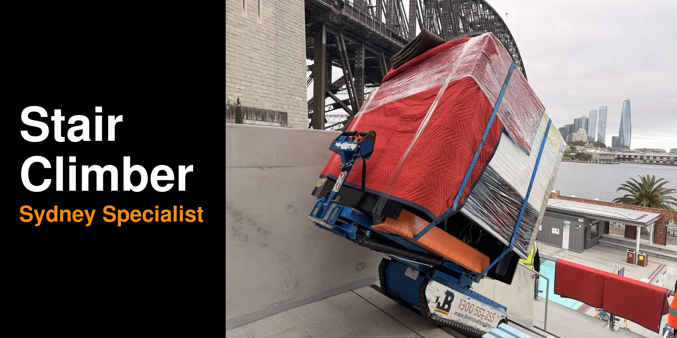 Stair Climber — Sydney Specialist, with JB’s blue tracked machine and wrapped load beside the Harbour Bridge