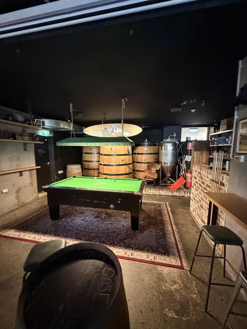 4 Pines Barrel Room interior with brewing vessels beyond the pool table