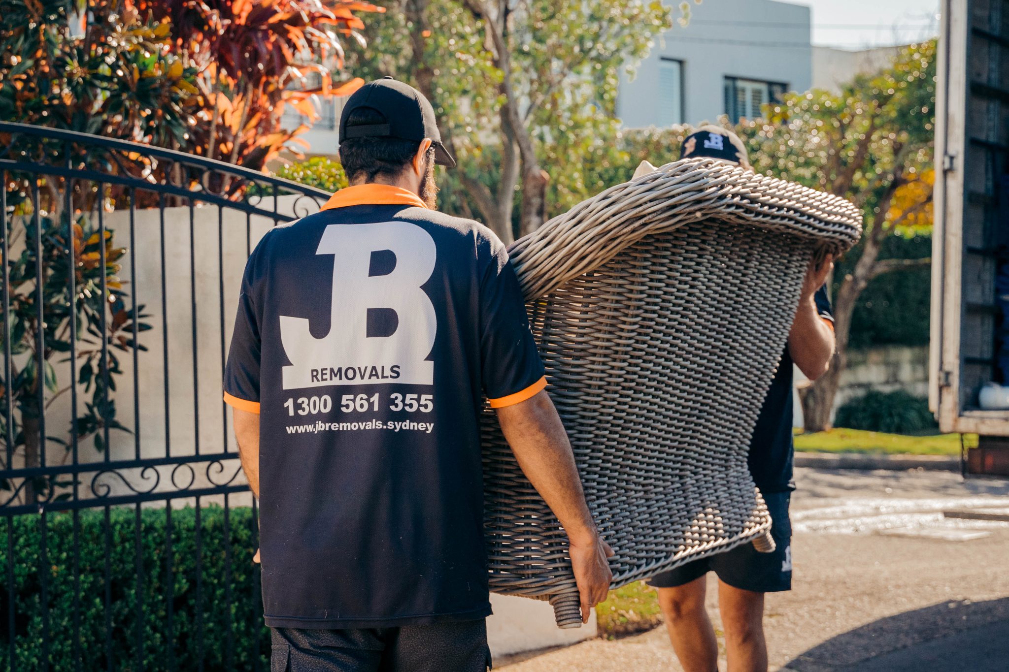 JB Removals crew carrying professionally protected furniture during a Sydney home move