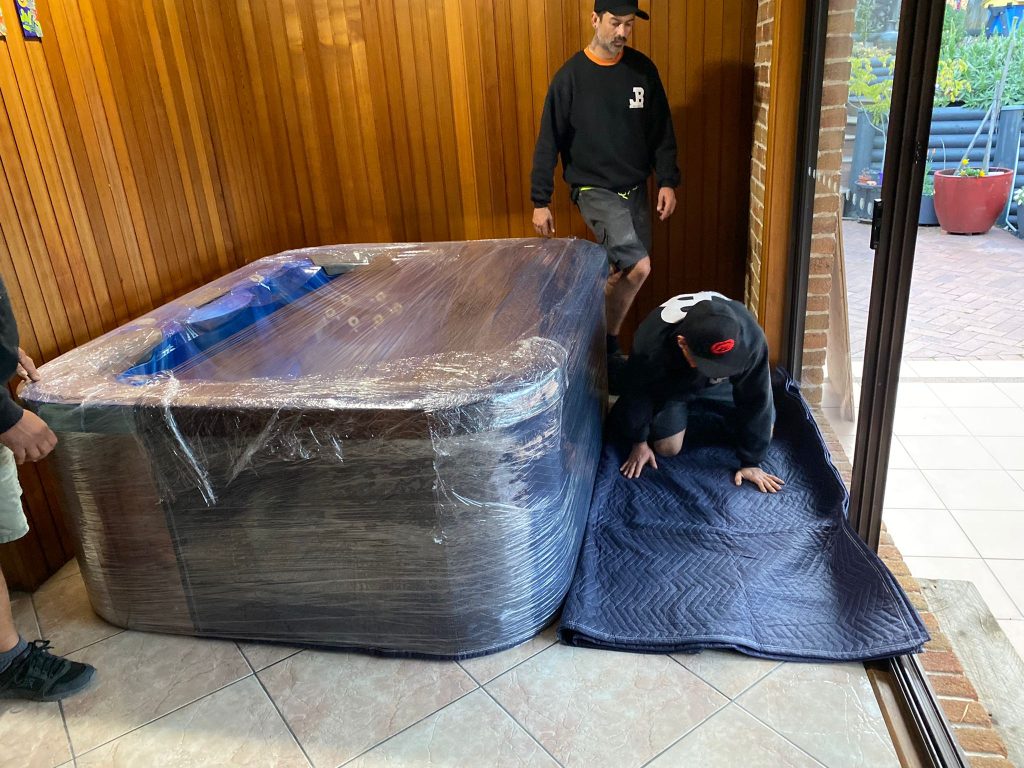Eight-person spa protected with wrapping and removal blankets before a Northern Beaches move