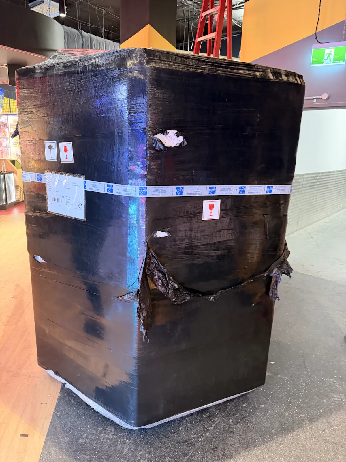 Large arcade machine fully wrapped to protect its glass and sensitive surfaces