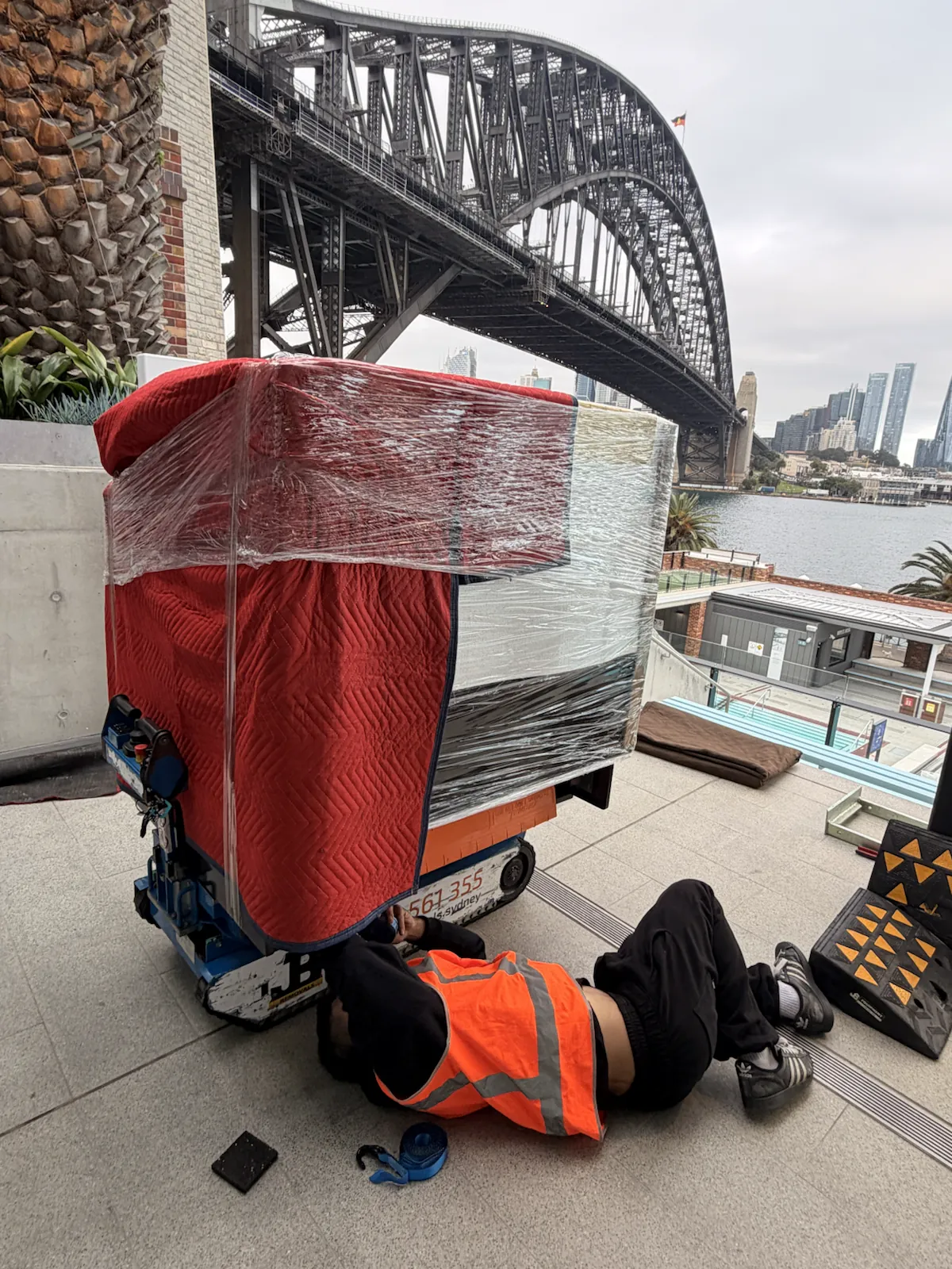 JB Removals crew member checking restraints beneath a protected gelato display fridge