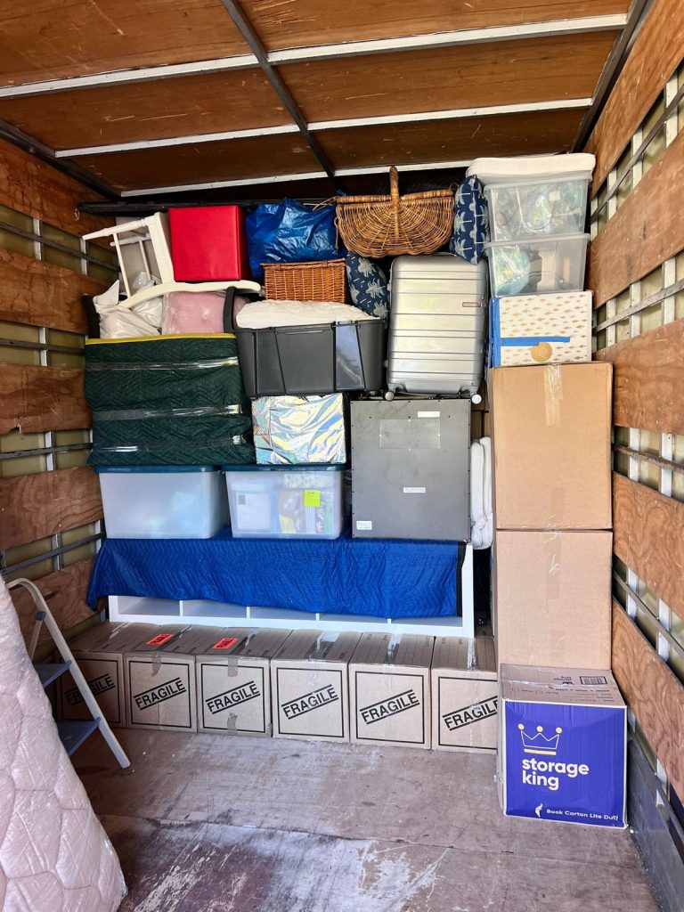 Protected household furniture and cartons loaded inside a moving truck