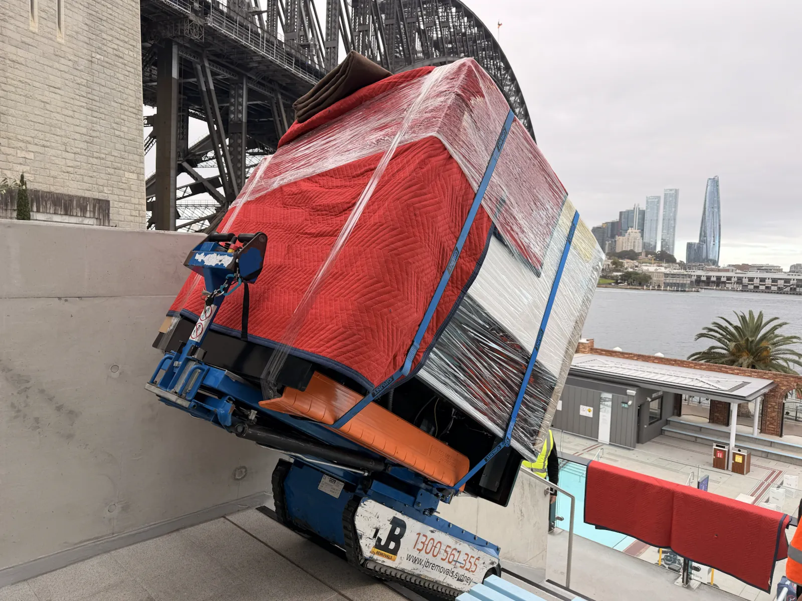 Protected gelato display fridge secured on the Hercules stair climber during a Sydney commercial relocation