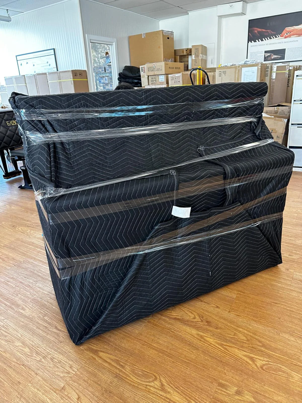 Upright piano protected with moving blankets by JB Removals