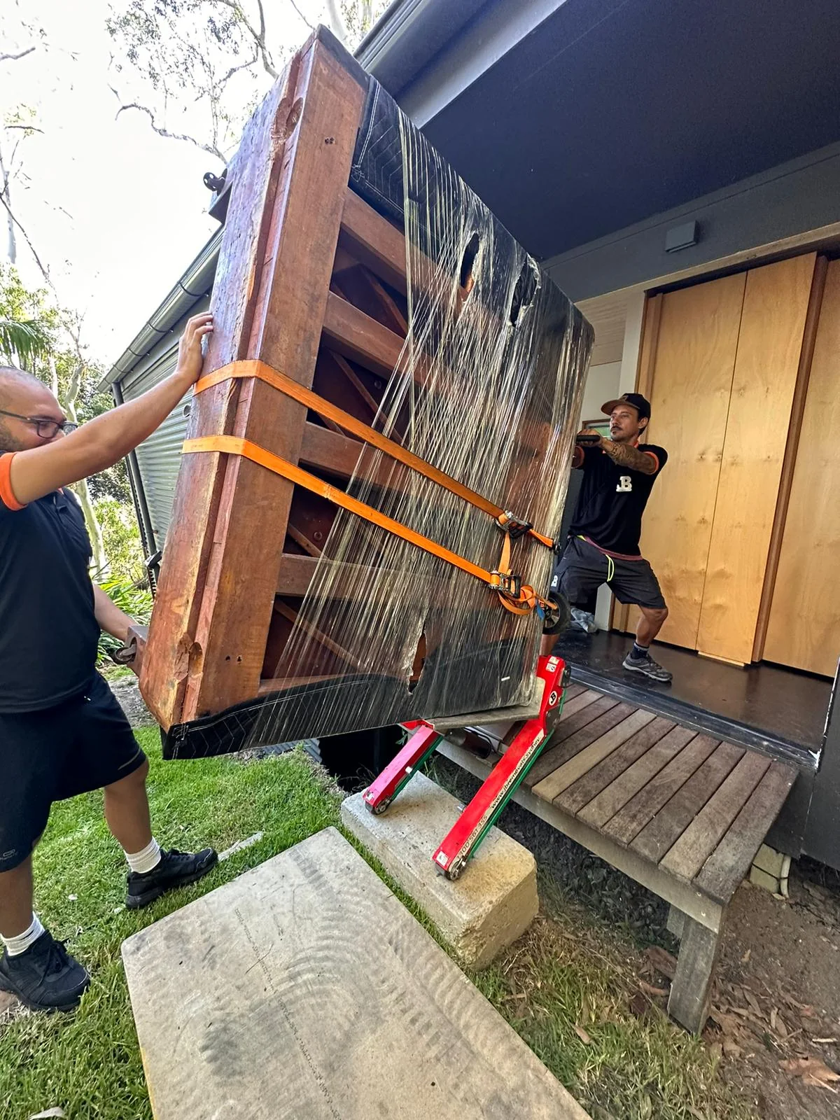 Protected upright piano controlled at a residential doorway