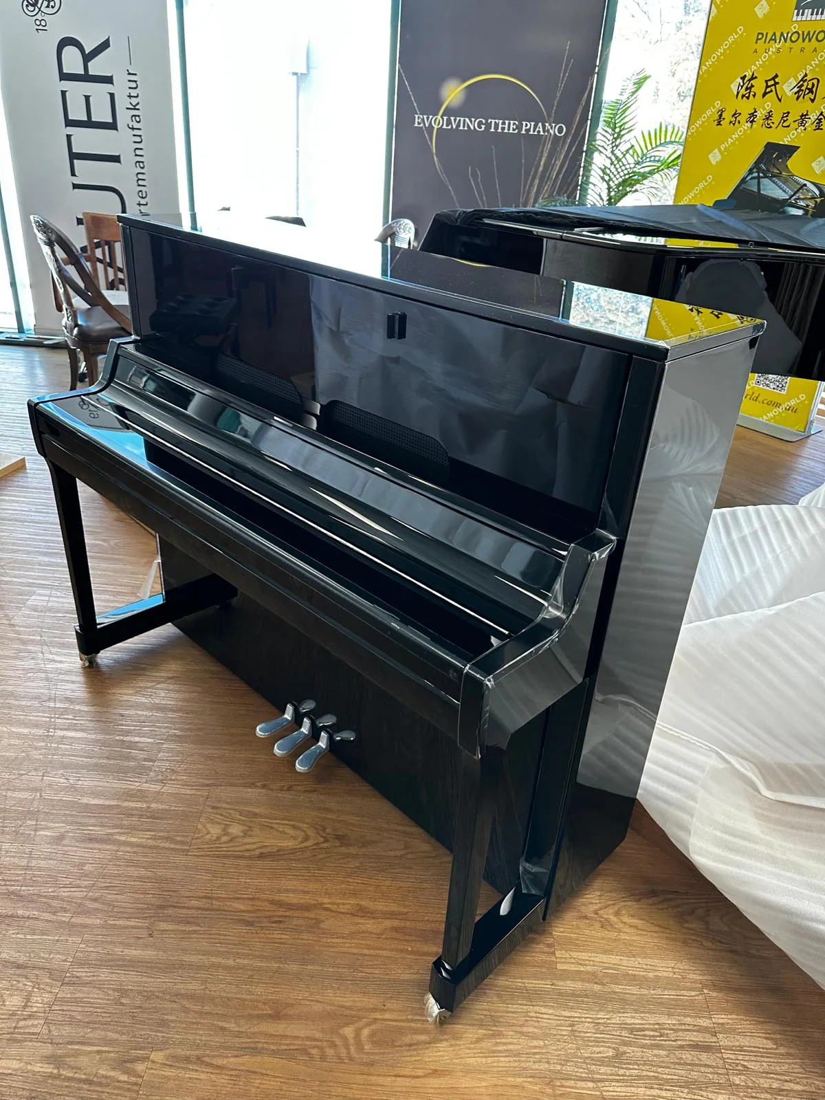 Upright piano photographed before a JB Removals move