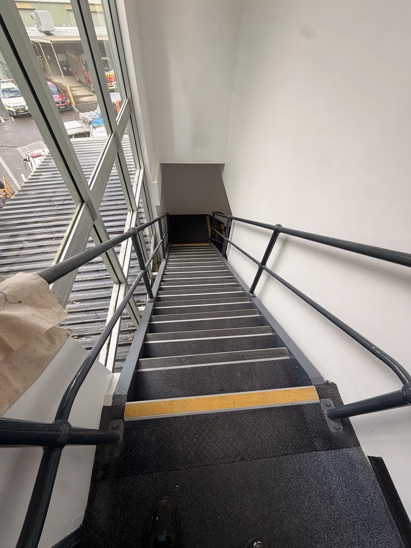 Internal staircase with handrails and a restricted landing on the safe removal route