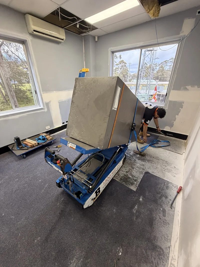 Safe body tilted and restrained on blue JB powered stair-climbing equipment