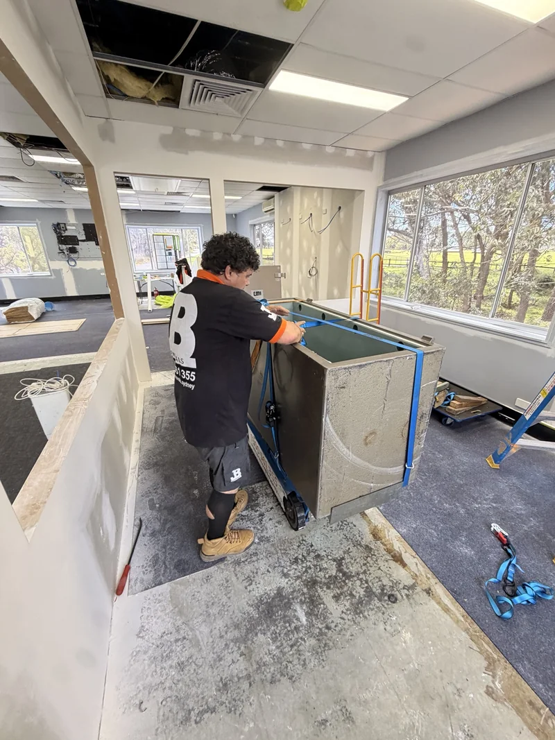 JB specialist preparing the open safe body and restraints inside the building