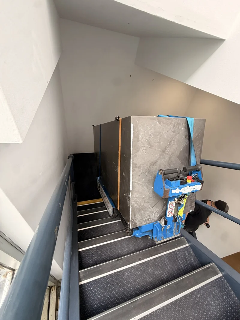 Safe body secured to JB stair-climbing equipment within a narrow internal staircase