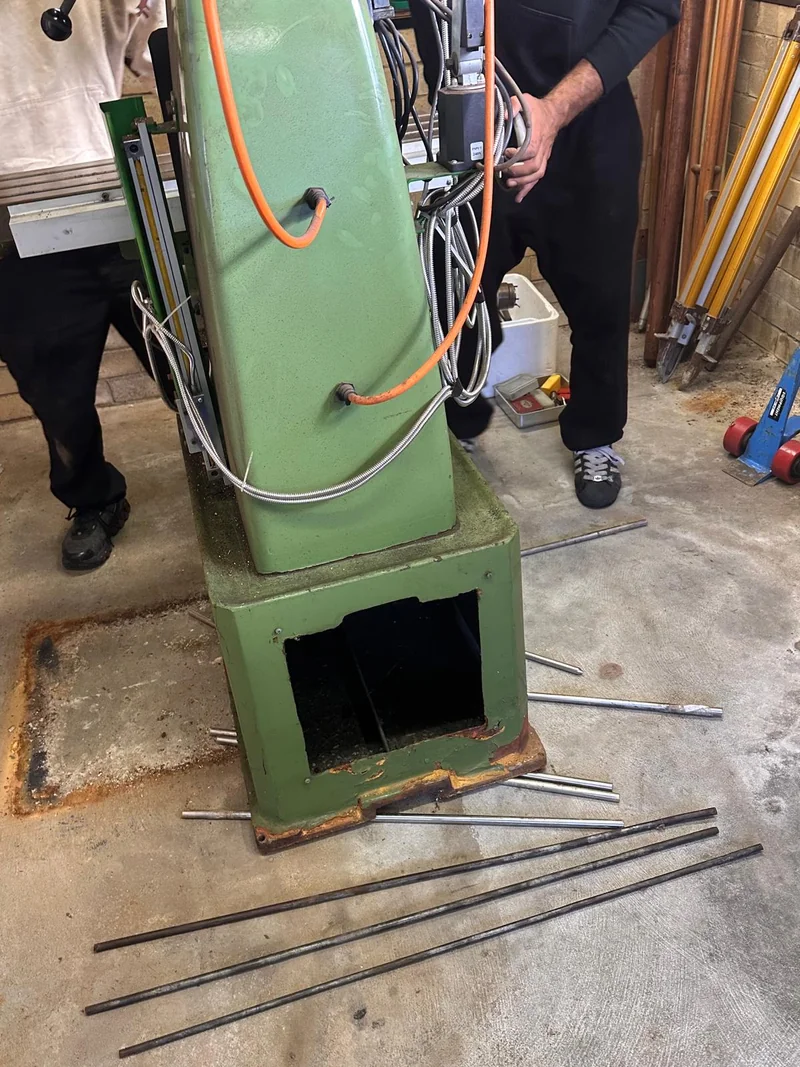 Rear of a milling machine with steel rollers beneath and around its base