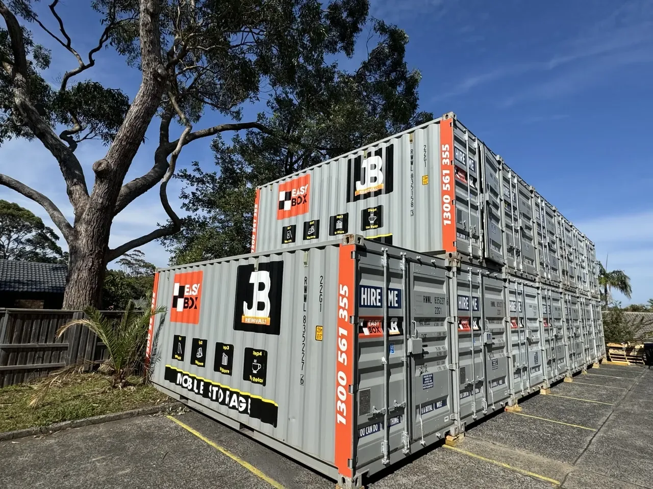 Branded EasyBox storage containers stacked in JB’s Sydney facility yard