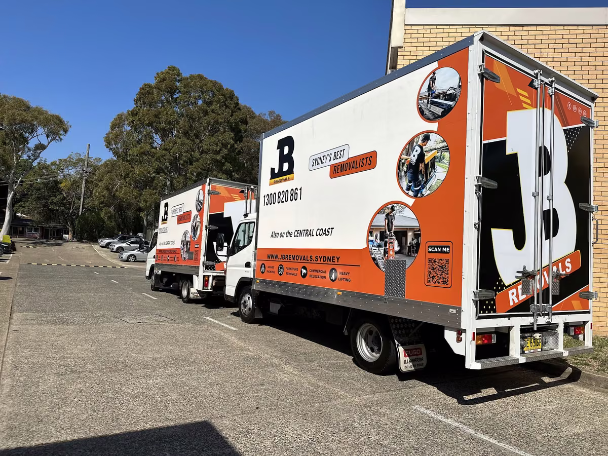 Two branded JB Removals trucks at the Sydney facility