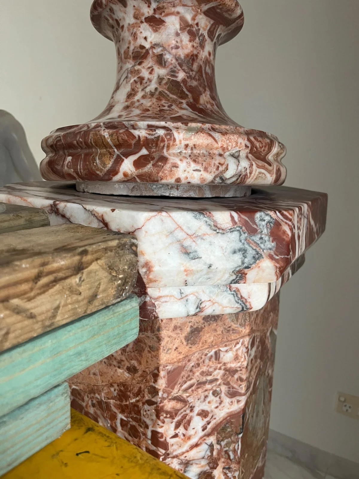 Close-up of the decorative urn foot and pedestal top beside timber blocking