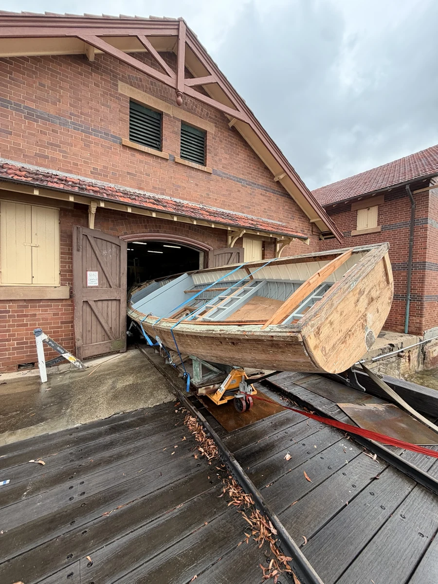Boat extending outside the brick warehouse after passing through the doorway