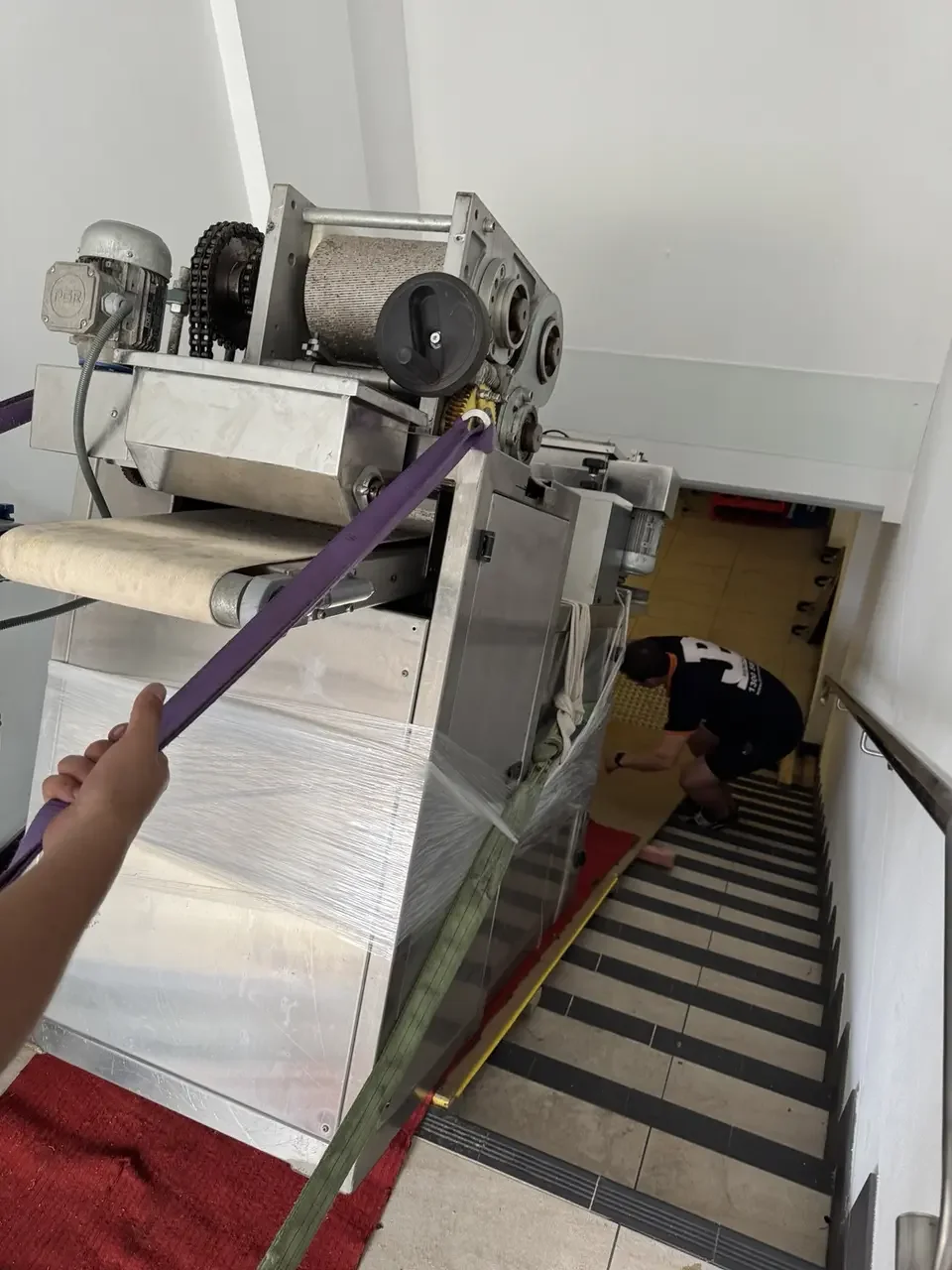 The commercial machine supported on equipment during the ramp move.