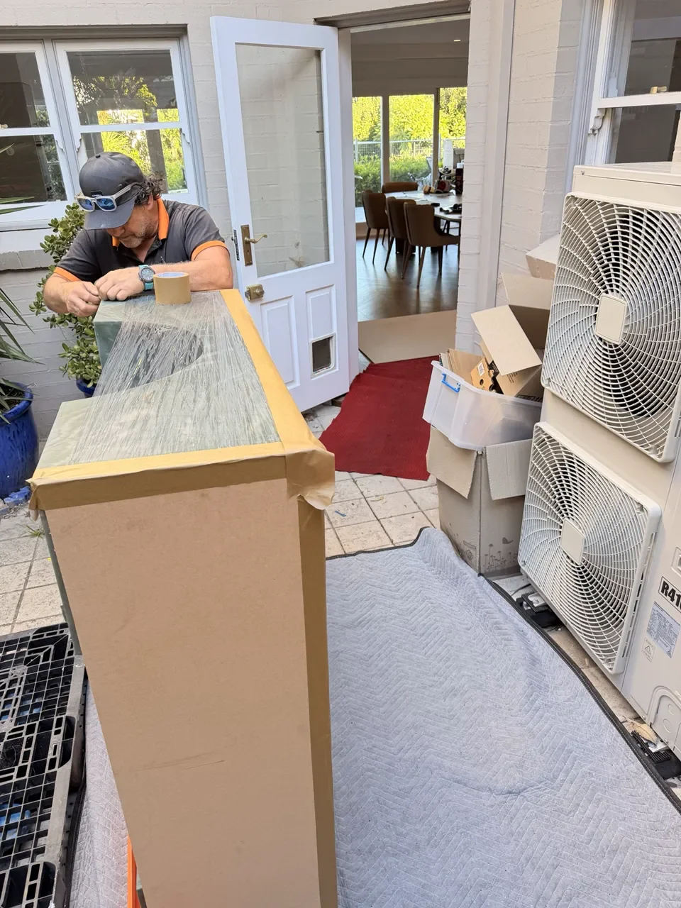 JB crew preparing rigid protection around the marble table.