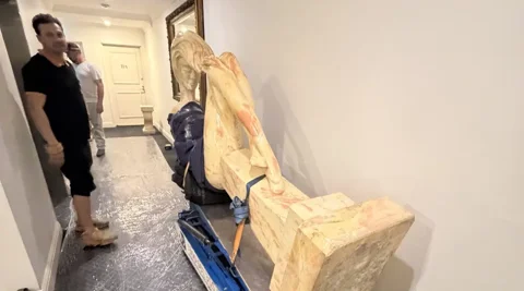A 700kg marble sculpture mechanically tilted on a JB Removals stair climber inside a protected building corridor