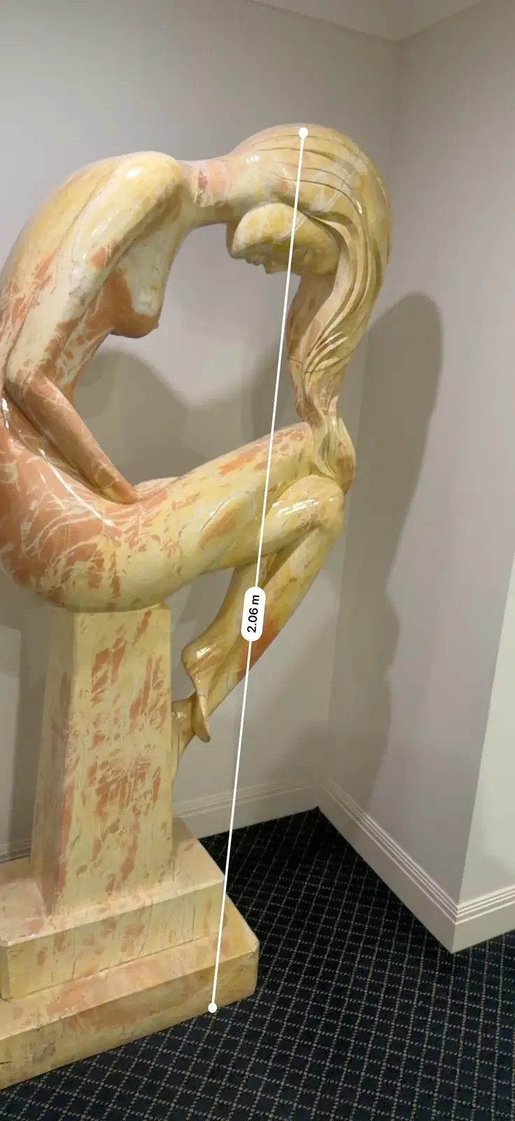 The upright marble sculpture and its surrounding corridor.