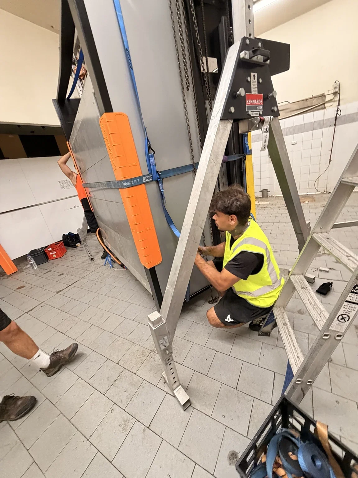 JB crew member beside a strapped commercial oven and portable gantry