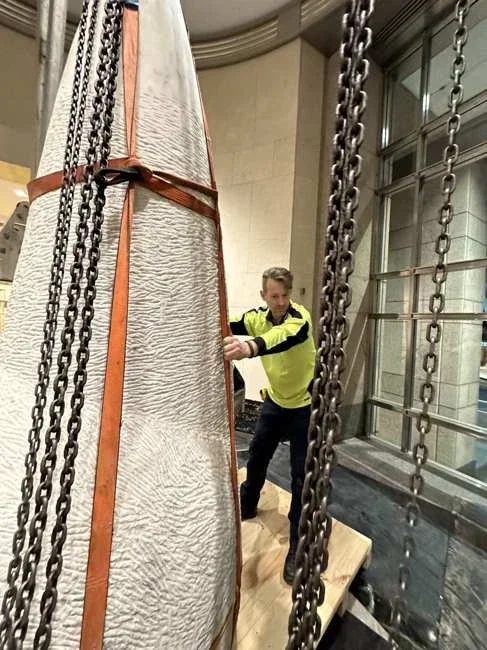 Close view of the tall marble base with orange straps and chains