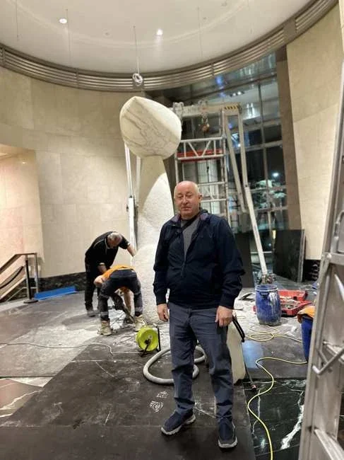 Team working around the sculpture sections in the lobby