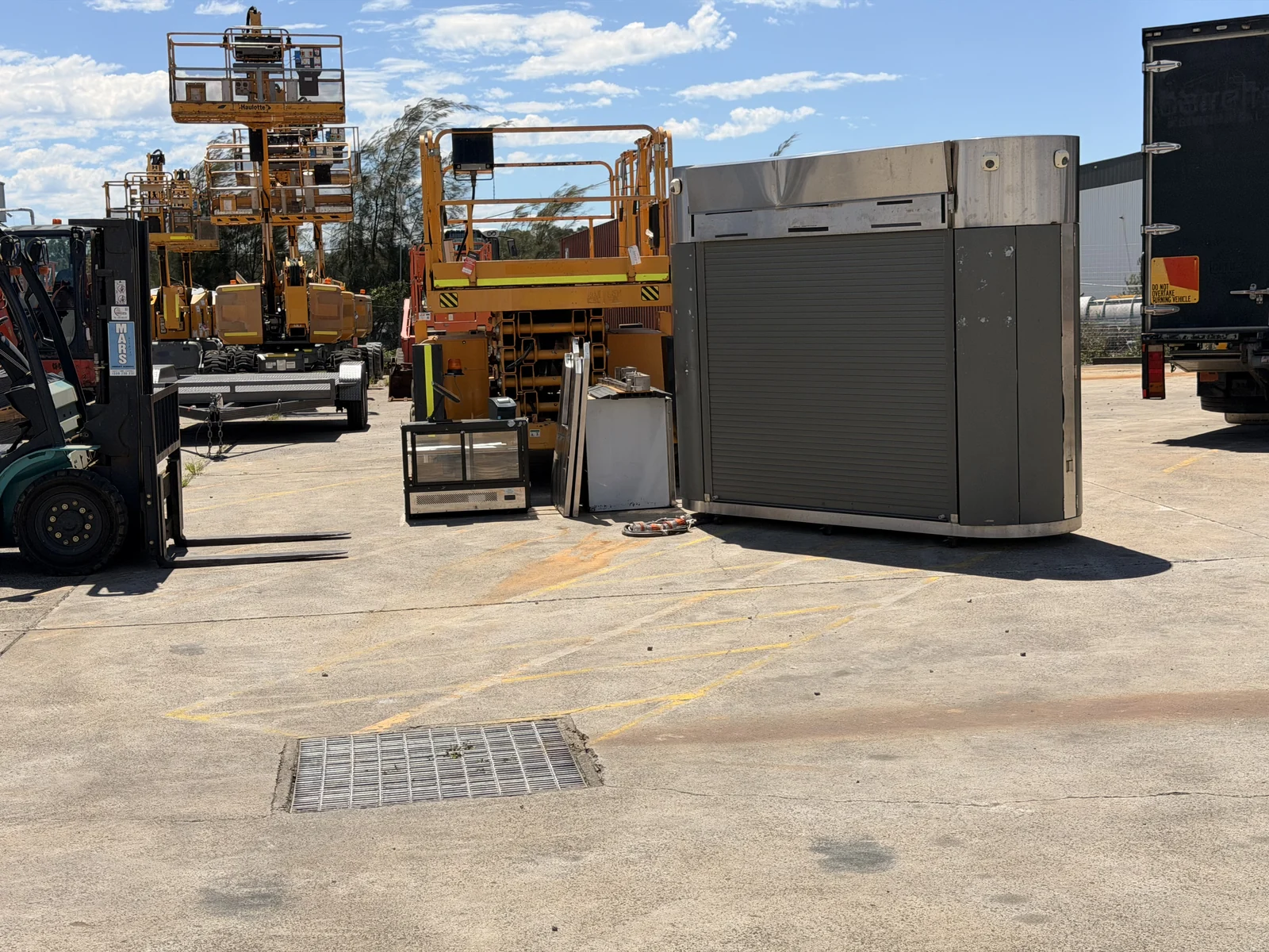 The relocated coffee kiosk and separate components at the receiving yard.