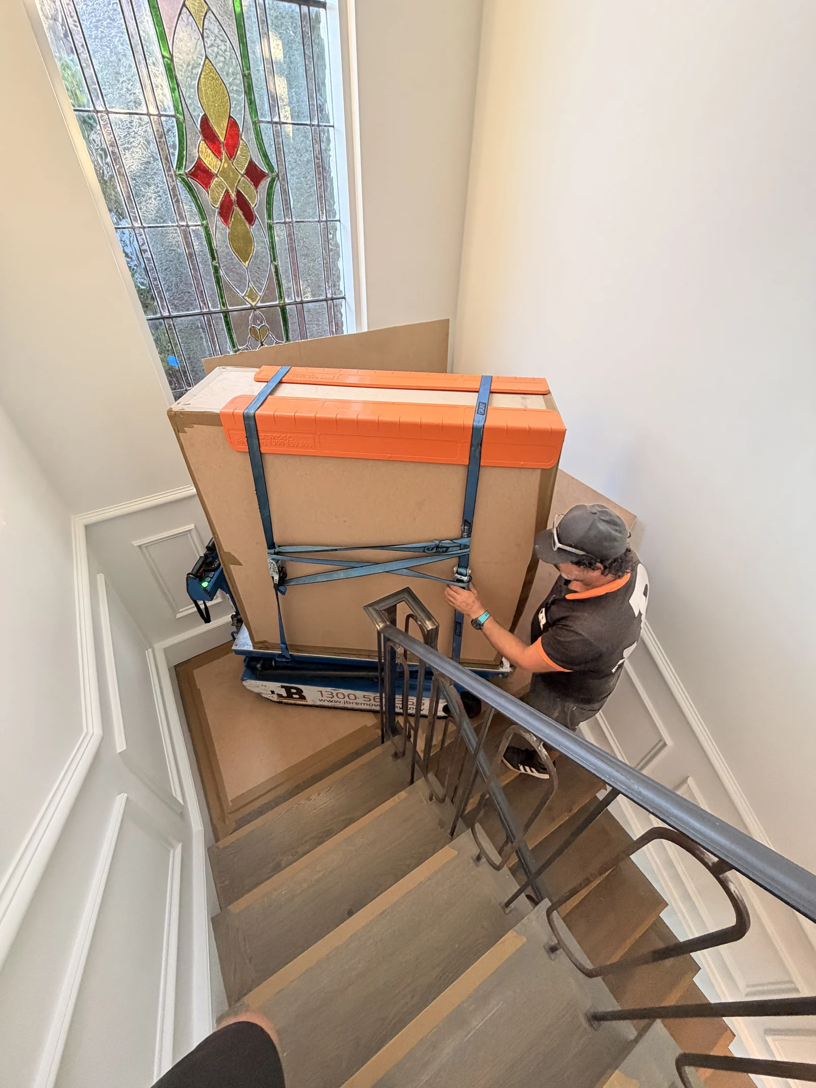 A JB specialist controlling the protected marble table on the staircase.