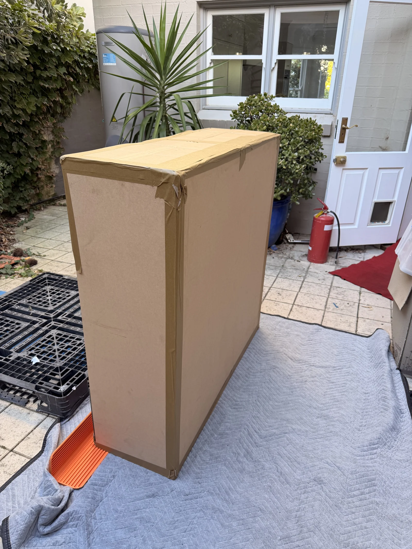 The marble table enclosed in protective casing before stair movement.