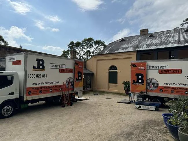 JB removal trucks and moving equipment at a residential property
