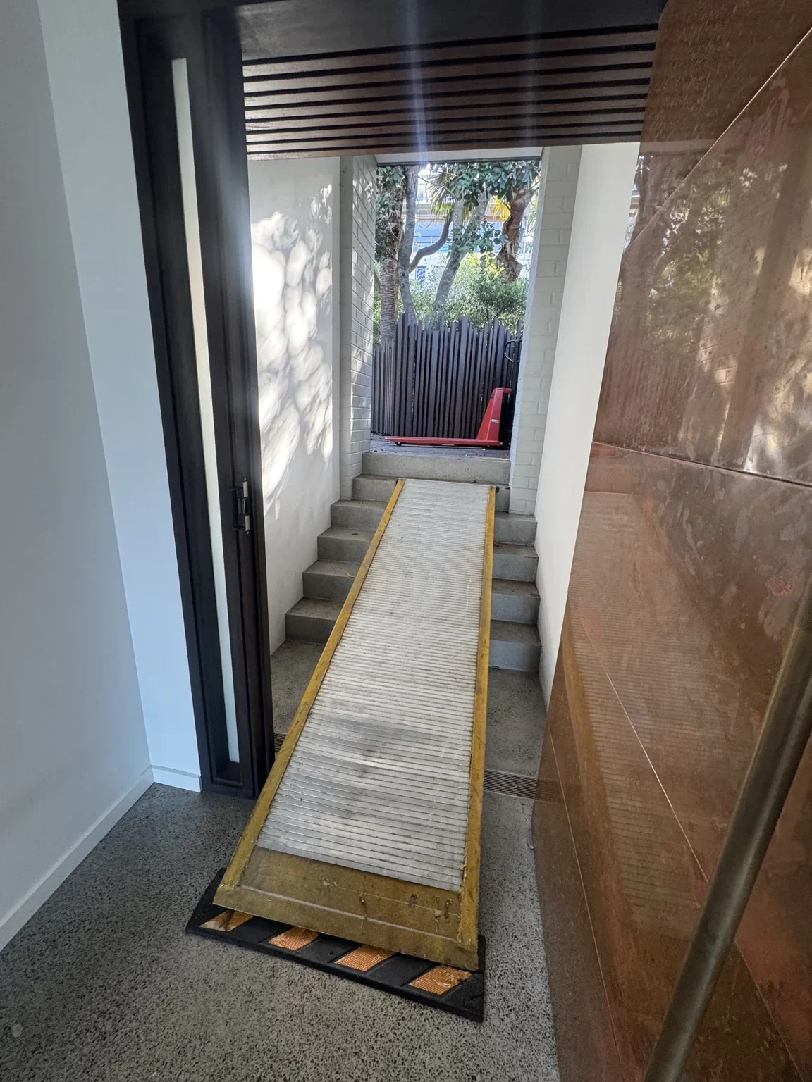 Long ramp laid across the concrete stairs in a narrow passage