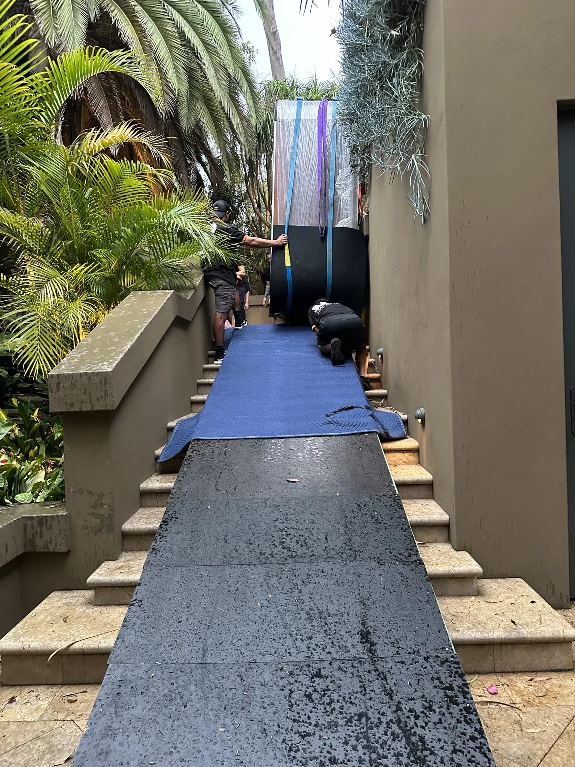 Protected spa at the end of a ramp spanning an outdoor staircase