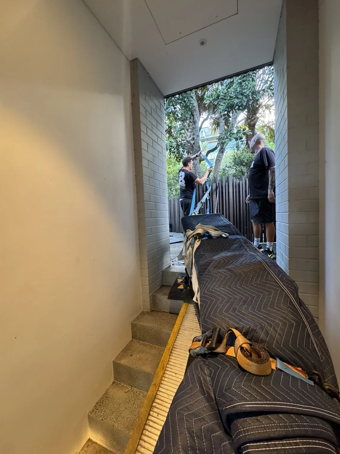 Long marble bench covered with moving blankets and straps on the stair ramp