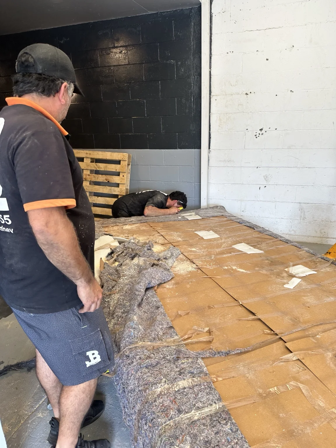 JB Removals team checking the wrapped tabletop during handling preparation