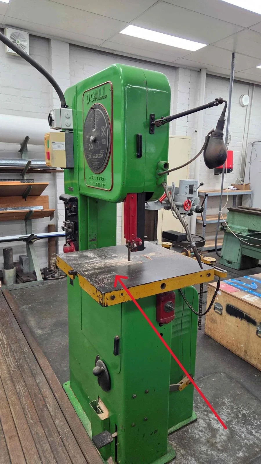 Green vertical bandsaw marked for the Sydney machinery relocation