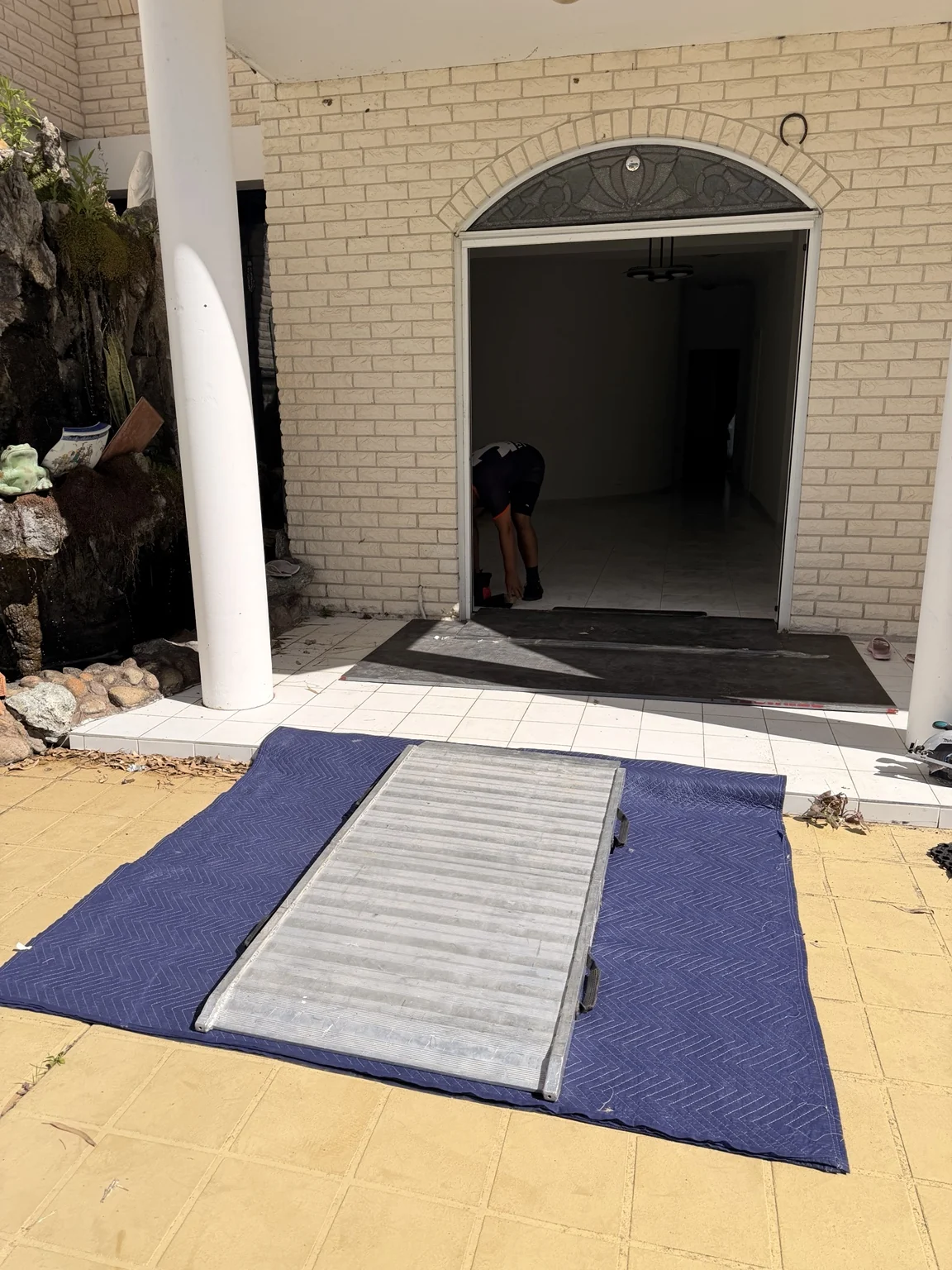 Portable ramp and protective blankets at a doorway transition