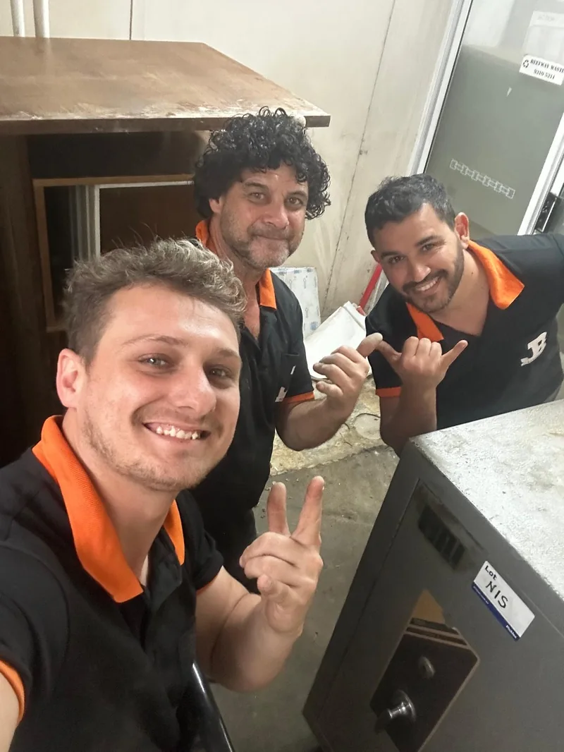 JB Removals crew beside the safe at a narrow doorway in Sydney