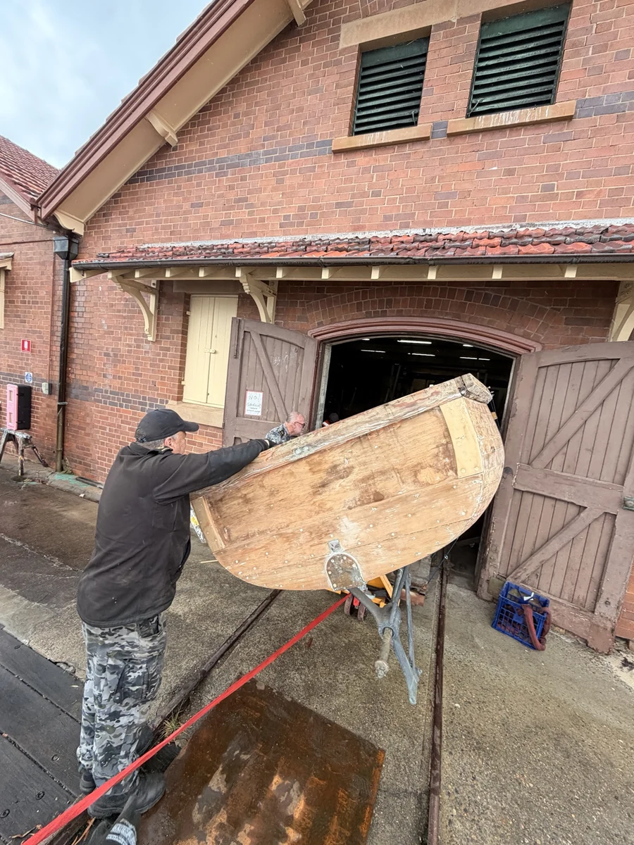 Boat supported at an angle through a restricted warehouse doorway